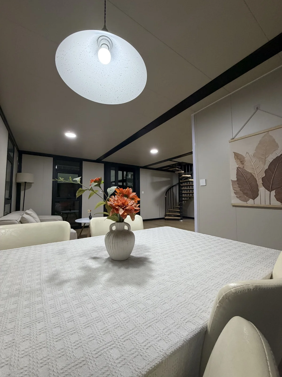 Dining area and internal staircase in a double-storey custom expandable house